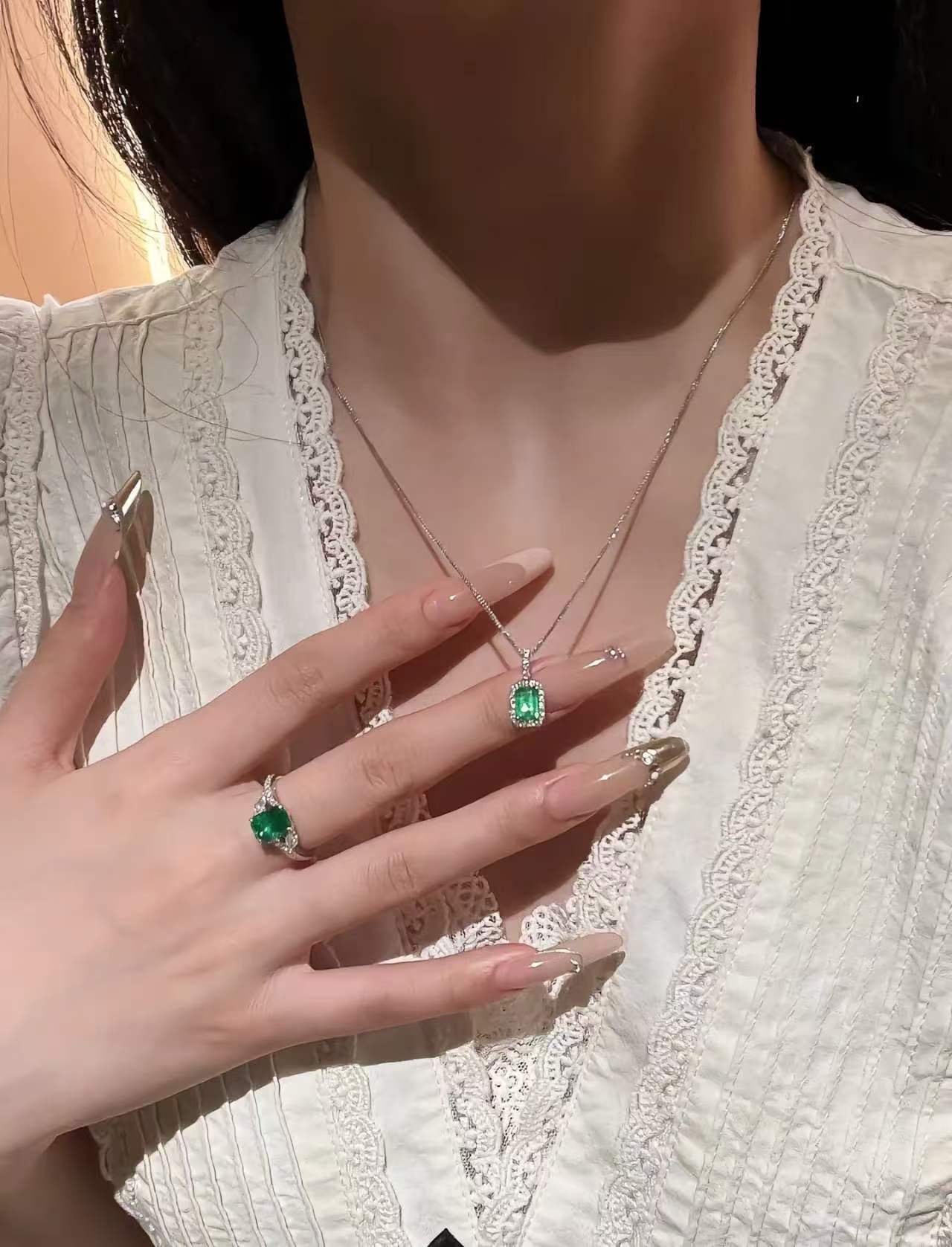 Jardin emerald-cut pendant worn over a lace blouse